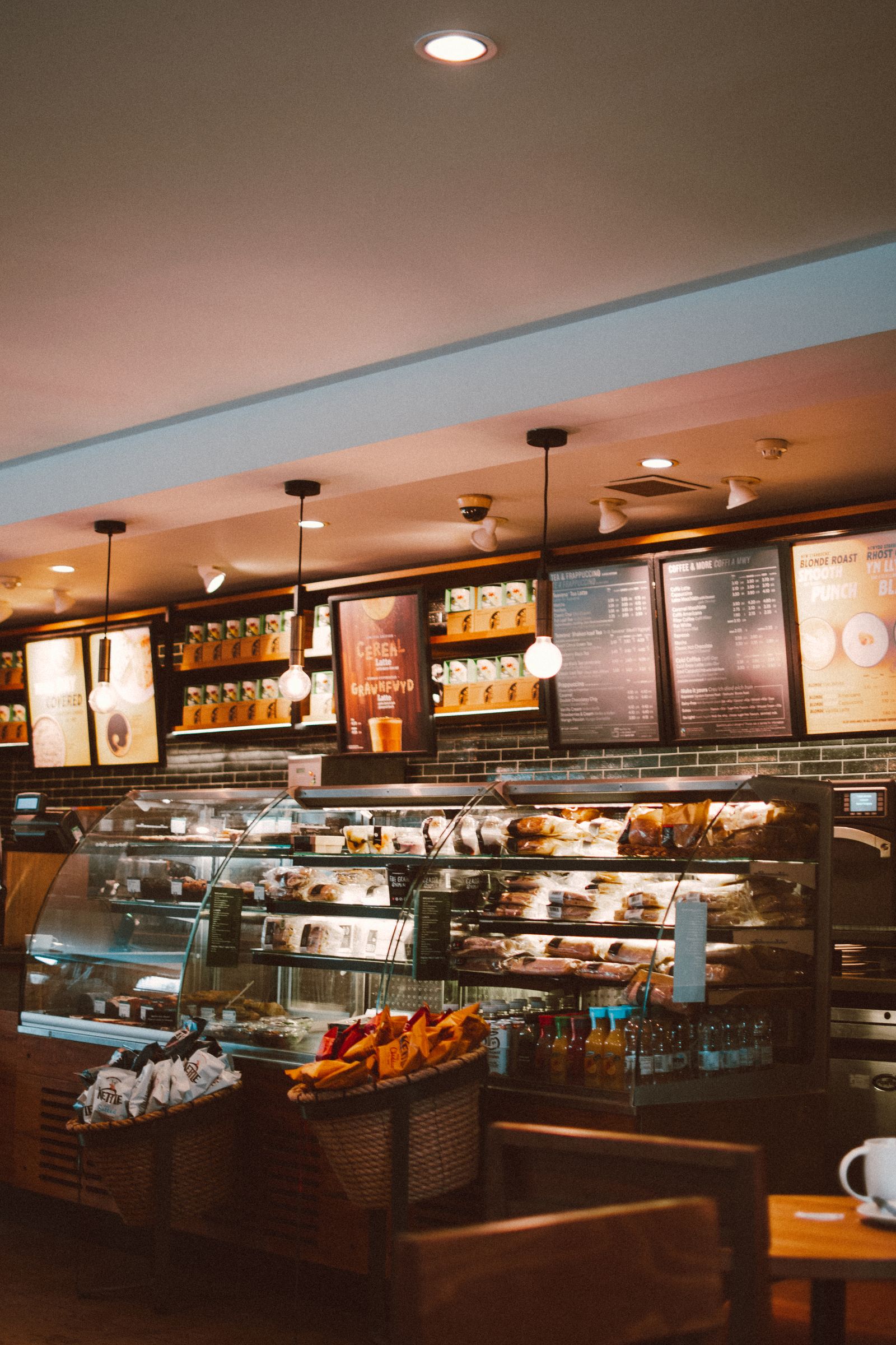 The bakery counter stacked with fresh pastries and bread under warm pendant lights