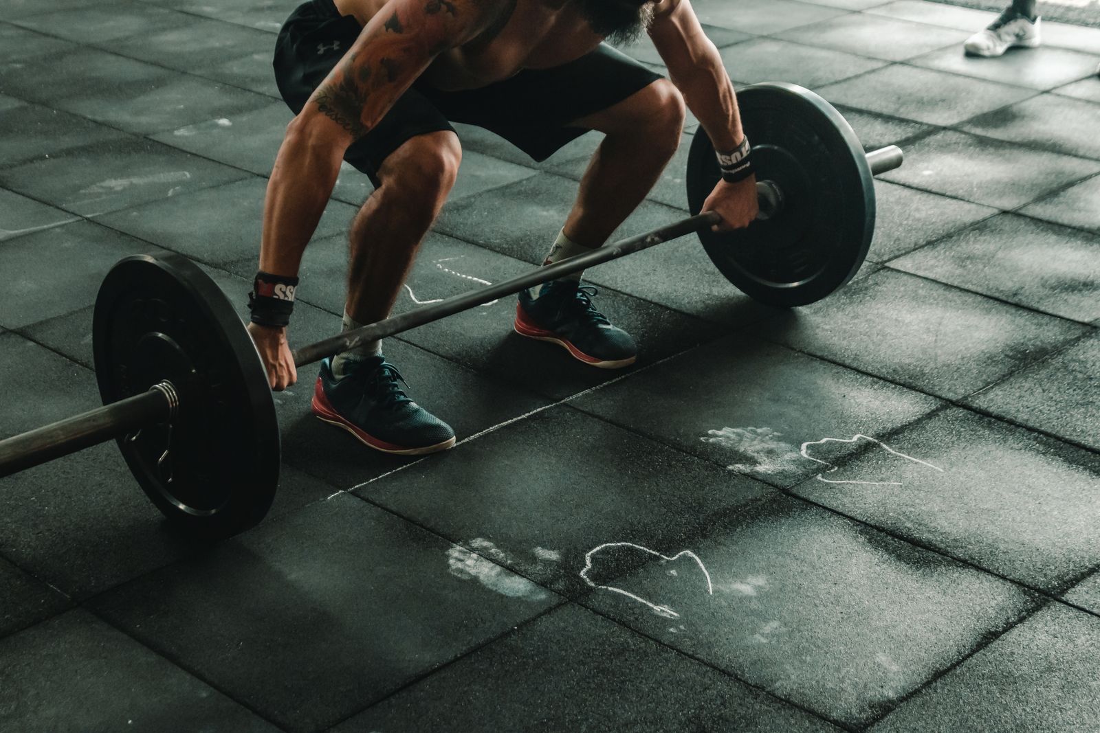 Lifter setting up for a heavy deadlift on a platform